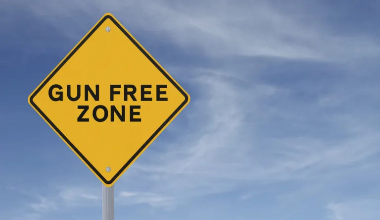 Gun,Free,Conceptual,Road,Sign,(against,A,Blue,Sky,Background)
