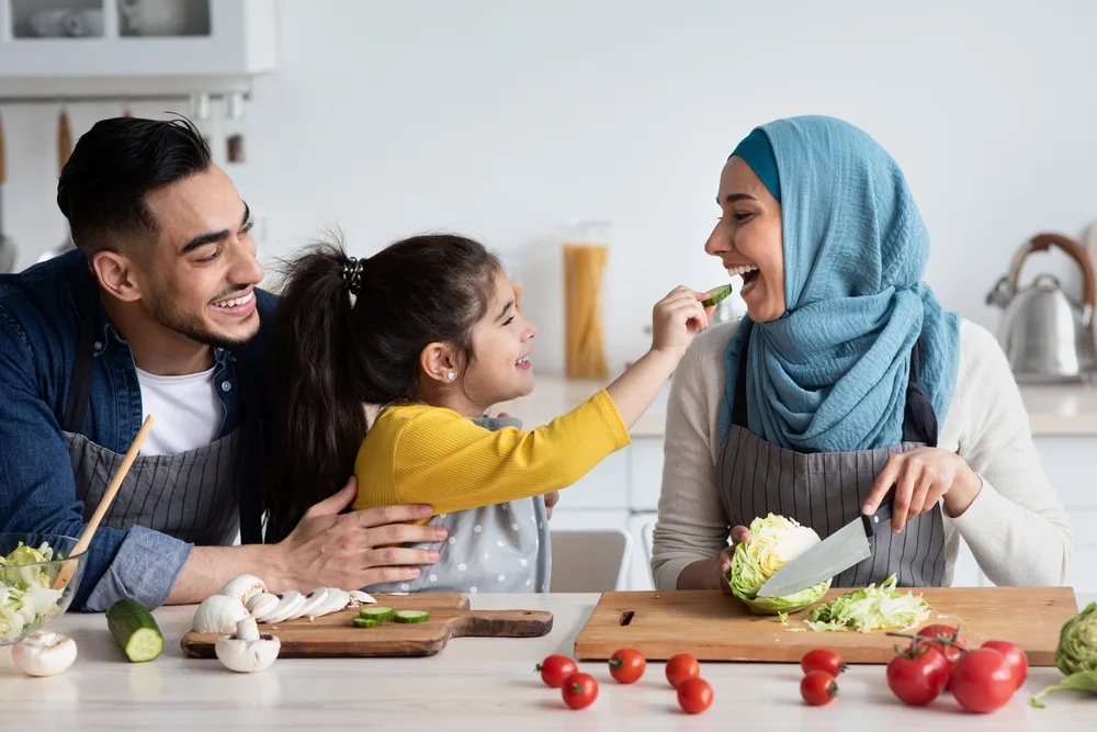 Portrait,Of,Cute,Little,Arab,Girl,Feeding,Muslim,Mom,With